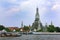 Colorful tourist boats and Wat Arun temple in Bangkok, Thailand