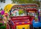 Colorful tourist rickshaw with tassels and flowers awaits the next tourist passenger