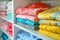 Colorful towels and clothes on shelves, organized