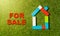 Colorful toy blocks house and For sale text Written on green grass in Investment Property industry