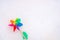 Colorful toy pinwheel on the white snow, background with copy space