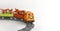 Colorful toy train with gifts on curve railway on white background.