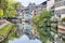 Colorful traditional houses reflecting in river Ill in Strasbourg