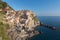 Colorful traditional houses on a rock over Mediterranean sea on dramatic sunset, Manarola, Cinque Terre