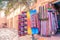 Colorful traditional Moroccan scarves and shawls hanging on a tree for sale. Ouarzazate, Morocco.