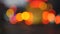 Colorful traffic lights bokeh circles on night city street. Abstract background