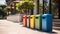 Colorful trash bins in front of a modern building with trees