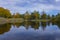 Colorful trees and a river in a morning Symmetry reflections on the water