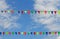 Colorful triangular flags hanging on the blue sky