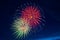 A colorful triple-burst of fireworks. Brightly colorful fireworks and salute of various colors