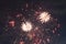 A colorful triple-burst of fireworks. Brightly colorful fireworks and salute of various colors