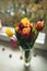 Colorful tulips in a vase on as a valentines gift. Bouquet of tulips lying on windowsill. Top of view. Natural background. Concept