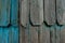 Colorful turquoise larch tree wood panel decorations used to cover the outside wall of houses in the Lake District of Chile in the