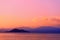 Colorful twilight seascape. Clouds and mountains on the horizon