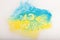 Colorful Ukrainan flag yellow blue color holi paint powder explosion isolated on white background. russia ukraine conflict war