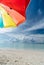 Colorful umbrella on paradise white sand beach and blue sky in sandbank island, Maldives