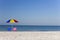 Colorful Umbrella, Pink & Blue Deckchairs on Beach