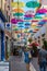 Colorful umbrellas cover a shopping street in Carcassonne, Aude, Occitanie, France. 08. 14. 2020 France