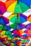 Colorful umbrellas. Rainbow colors. Protection against rain. Open umbrellas under the roof.