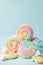 Colorful unicorn rainbow color meringue lollipops candy on blue background. Flat lay. Summer sweet abstract Minimal concept.