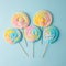 Colorful unicorn rainbow color meringue lollipops candy on pale on blue background. Flat lay. Summer sweet abstract Minimal