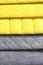 Colorful upholstery fabric samples. Close-up of samples of furniture fabric. Yellow and grey fabric with stitch effect. Furniture