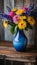 A colorful vase filled to the brim with fresh flowers perched atop a rustic wooden table displays a burst of blooms.