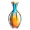 A colorful vase with a rainbow design sits on a transparent background