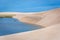 The colorful vast desert landscape of tall, white sand dunes and seasonal rainwater lagoons at the LenÃ§Ã³is Maranhenses National