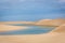 The colorful vast desert landscape of tall, white sand dunes and seasonal rainwater lagoons at the LenÃ§Ã³is Maranhenses National