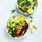 Colorful vegetable bowl with bulgur and chickpeas and kale-bulgur tabbouleh with garlic lime dressing