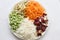 Colorful vegetables arranged in plate with white background