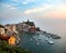 The colorful Vernazza harbor in the Cinque Terre at sunset