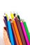 Colorful vertical pencil crayon border over white