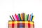 Colorful vertical pencil crayon border over white