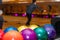 Colorful and vibrant bowling balls, with lanes in the background