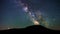 Colorful vibrant milkyway galaxy with stars and space dust in the universe above the dark hill