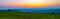 Colorful vibrant sunset, panoramic view to farm fields