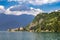 Colorful view of the bay of Varenna ancient city with cozy restaurant, hotel and ship in the port connecting famous town