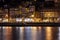 Colorful view at twilight along the riverfront with lights reflecting in the Douro River