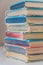Colorful vintage hardcover books stacked on table