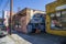 A colorful wall mural of a blue Ford Monster truck on the side of a red brick buildings in Little Five Points