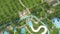 Colorful water slides in amusement aquapark on palm tree landscape. Drone view water slides in outdoor aqua park at