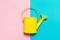 Colorful Watering Can on Colored Background. Flat Lay. Minimalistic Concept. Spring or Summer Concept.