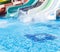 Colorful waterpark tubes, spray slides and pool in aquapark. Water park slides close up.