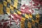 Colorful waving maryland state flag on a american dollar money background