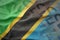 Colorful waving national flag of tanzania on a euro money banknotes background