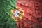 Colorful waving portuguese flag on a dollar money background