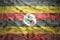 Colorful waving ugandan flag on a dollar money background