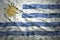 Colorful waving uruguayan flag on a dollar money background